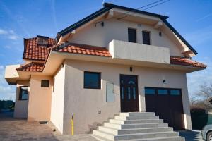 a small white house with a red roof at Ilic House in Belgrade