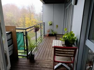 a balcony with potted plants and a table and chair at Stylish 2BD near Gatwick Airport in Crawley in Crawley
