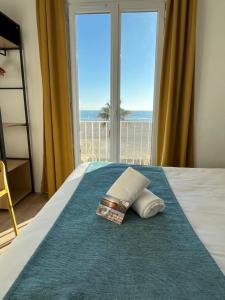 a bedroom with a bed with a view of the ocean at Hotel Saint Georges, Face à la mer in Canet-en-Roussillon +59 photos
