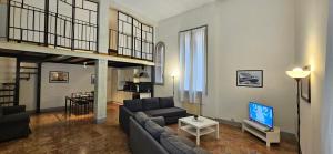 a living room with a couch and a tv in it at Residence Via Begatto 1 in Bologna