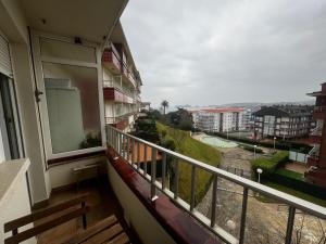 a balcony with a view of a city at Apartamento con vistas al mar y piscina II in Suances