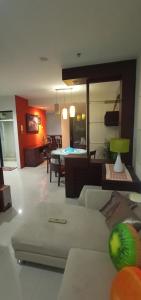 a living room with a couch and a table at Apartemen Thamrin City 2 BIG BR,85sqm,City View in Jakarta