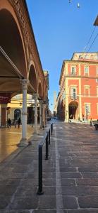 a city street with a building and a row of poles at Residence Via Begatto 1 in Bologna