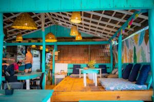 a room with a couch and a table and some people at Smile Beach Home in Galle