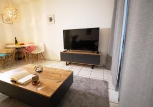 a living room with a large television and a table at Gemütliche 2Zi. Wohnung in Seligenstadt