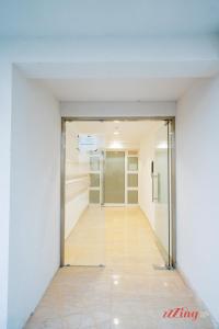 an empty hallway in a building with a glass door at A Stylishly Chic Holiday Home with SOFA BED - A12 in St Paul's Bay