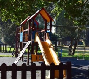 a playground with a slide in a park at Apartamento Esposende Quinta da Barca in Barca do Lago