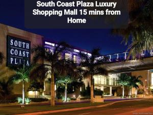 a sign that reads south coast plaza luxury shopping mall mins from home at Amazing Value with High Comfort, 14 Guests for 4BR by Disneyland, Beaches, Rodeo 39 & More in Midway City