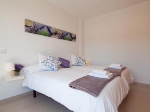 a white bed with towels on it in a room at Charmsuites Nou Rambla in Barcelona