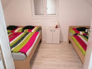 1 Schlafzimmer mit 2 Betten und bunten Decken in der Unterkunft Víkendový dom Hlboká in Dunajská Streda