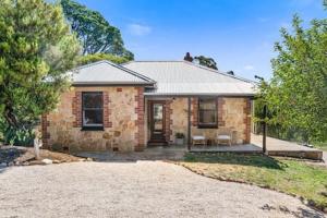 a brick house with a driveway in front of it at Rossini's Cottage - Hills Escape in Mount Lofty