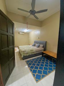 - une chambre avec un lit et un ventilateur de plafond dans l'établissement 192 homestay, à Alor Setar
