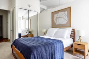 a bedroom with a large bed with a blue blanket at Culver City 2BR w Gym Pool nr shops LAX-343 in Los Angeles +25 photos