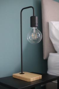 a light on a table with a lamp on it at Shamrock House- 2 BR House, Free Parking & WIFI in Ipswich
