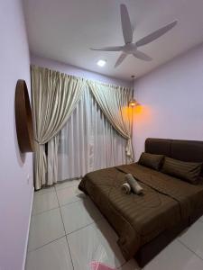 a bedroom with a bed and a ceiling fan at Eighty2 House Palmyra Residence in Bangi