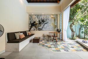 a living room with a couch and a table at Enigma Villa Canggu in Canggu