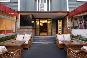 a patio with couches and tables on a building at Cord Hotel & Resort in Edremit