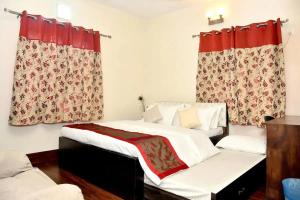 a bedroom with a bed with red curtains at Orchid B&B in Kolkata