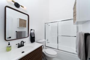 a bathroom with a shower and a toilet and a sink at Downtown Beach Home, 5 min to Beach! Backyard, BBQ in Huntington Beach
