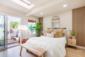 a bedroom with a large bed and a table at Walk to Beach! Patio, Rooftop, Yard, BBQ! Downtown Huntington in Huntington Beach