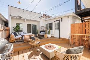 a patio with chairs and a table on a deck at Walk to Beach! Patio, Rooftop, Yard, BBQ! Downtown Huntington in Huntington Beach +22 photos
