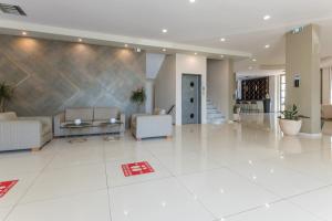 A seating area at Gouves Bay by Omilos Hotels