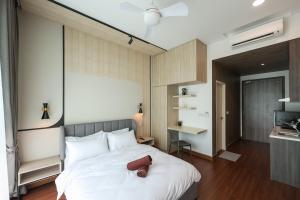 a bedroom with a bed and a desk in it at Greenfield Residence, Bandar Sunway by The Comfort Zone in Petaling Jaya