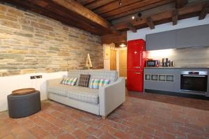 a living room with a couch and a kitchen at Aurturist Miramonti S Candido in San Candido