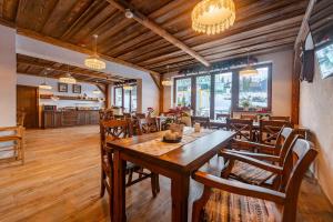 a dining room with a wooden table and chairs at Penzión JANÍK JASNÁ in Belá