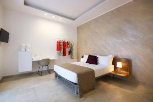 a bedroom with a bed and a desk in it at VILLA GENTILE RESORT E SPA in Cassano delle Murge