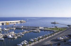 a marina with boats parked in the water at HAPPYVILA Rustico Apartments in Villajoyosa