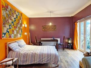a bedroom with a bed and a table with a laptop at Coastal - Wittering in West Wittering