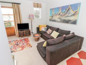 a living room with a couch and a tv at Ruan Dinas in Truro