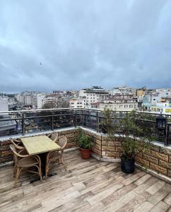 a patio with a table and chairs on a roof at Marmara Place Old City Hotel in Istanbul