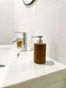 a bathroom sink with a soap dispenser on it at Elegante apartamento 6-8pax AV Palmera 3D 2B in Seville