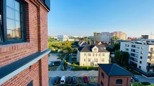 a view of a city from a brick building at Apartament w Młynie Różanka in Wrocław