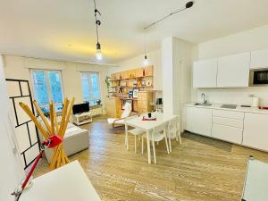 a kitchen and a living room with a table at LOFT IN PIAZZA VITTORIA in Treviso