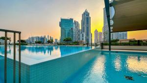 Top Floor Apartment with Burj Khalifa Views and Full Downtown Views171BC-2 في دبي: مسبح على أفق المدينة في الخلفية