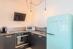 Kuchyňa alebo kuchynka v ubytovaní Appartement lumineux avec rooftop et garage privé.