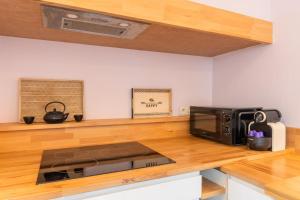 a kitchen with a microwave on a wooden counter at Renovated house with terrace 3 bedrooms in Wasquehal +21 photos