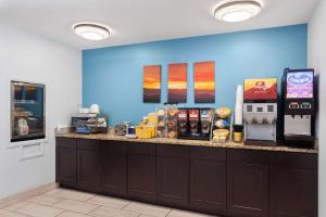a fast food restaurant with a counter with aperature at Days Inn & Suites by Wyndham Sellersburg in Sellersburg