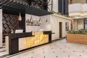 a lobby with a reception desk in a building at Ramada Encore By Wyndham Istanbul Basin Express in Istanbul