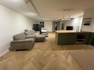 a living room with a couch and a table at APARTAMENT OVOC 1.0 in Chodzież