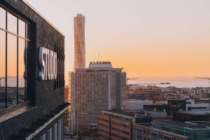 Blick auf eine Stadt bei Sonnenuntergang von einem Gebäude aus in der Unterkunft Story Hotel Studio Malmo, part of JdV by Hyatt in Malmö