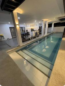 a swimming pool in the middle of a house at Villa Tobias San Juan Batangas in Batangas City