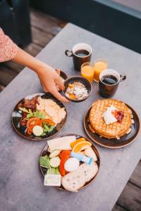 a table with four plates of food on it at Story Hotel Studio Malmo, part of JdV by Hyatt in Malmö