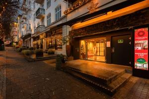 a store front of a building on a street at night at Ole Bull, Best Western Signature Collection in Bergen