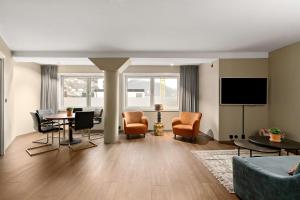 a living room with a couch and a table and chairs at Ole Bull, Best Western Signature Collection in Bergen
