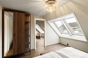 a bedroom with a bed and a chandelier at Ole Bull, Best Western Signature Collection in Bergen