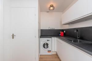 a kitchen with a washing machine and a sink at 2 BR house w/ terrace, near train stations & metro in Lille +18 photos